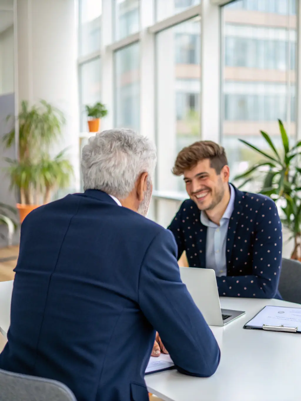 A senior executive participating in a FitIQ workshop, actively engaging with younger colleagues in a knowledge-sharing session.